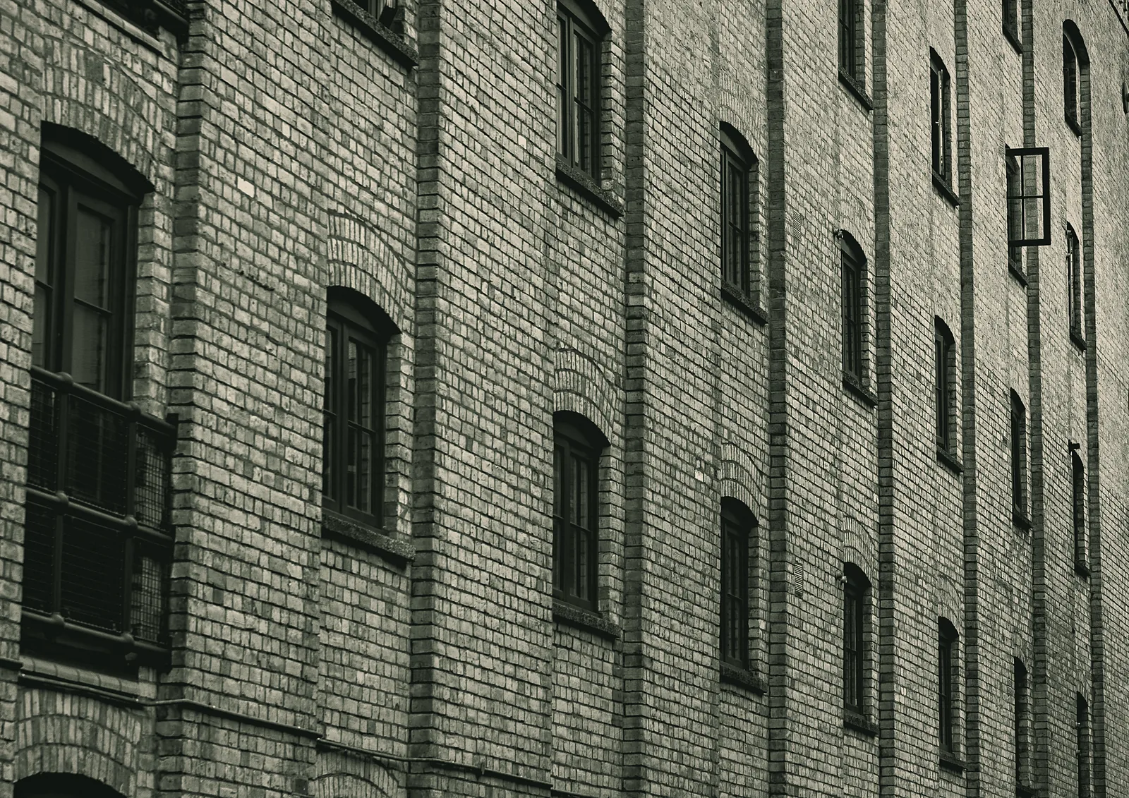 Brick facade with rows of arched windows